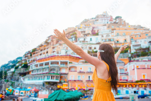 Summer holiday in Italy. Young woman in Positano village on the background, Amalfi Coast, Italy © travnikovstudio