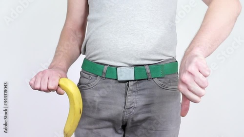 A man demonstrates the big banana raising it up and down.