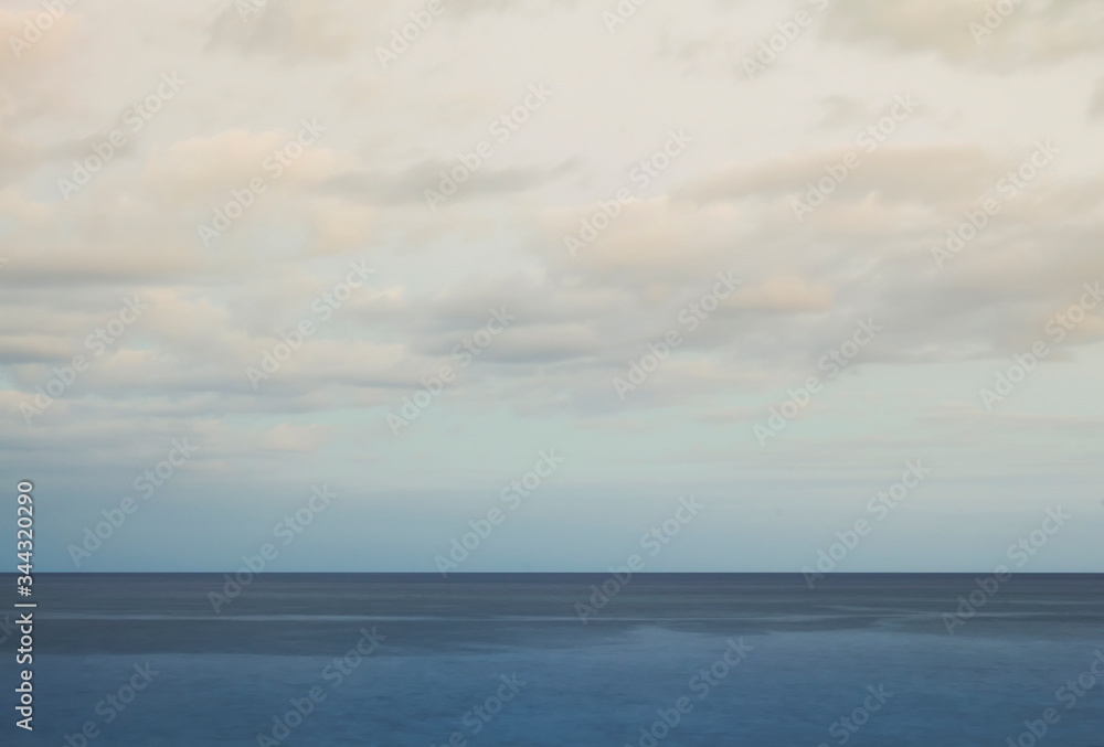 Minimalist seascape with blue waters and cloudy sky