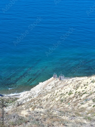 Magnificent view from the height of the blue sea. It shines in the sun.