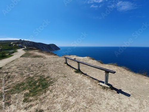View from the mountain to the Black sea on a Sunny day. Bench for enjoying the beautiful views. Spring in Anapa, Krasnodar territory.