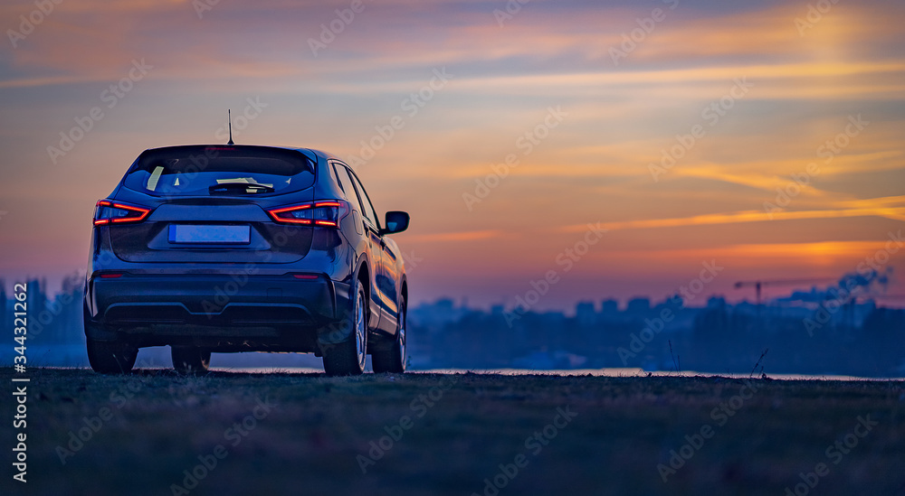 car at sunset, on city background.