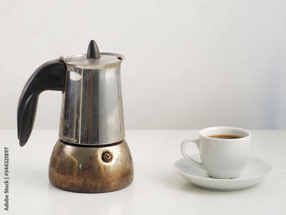 Cup and coffee pot with Dominican Republic.coffee on white table. Cup and coffee pot with Dominican Republic.coffee on white table.