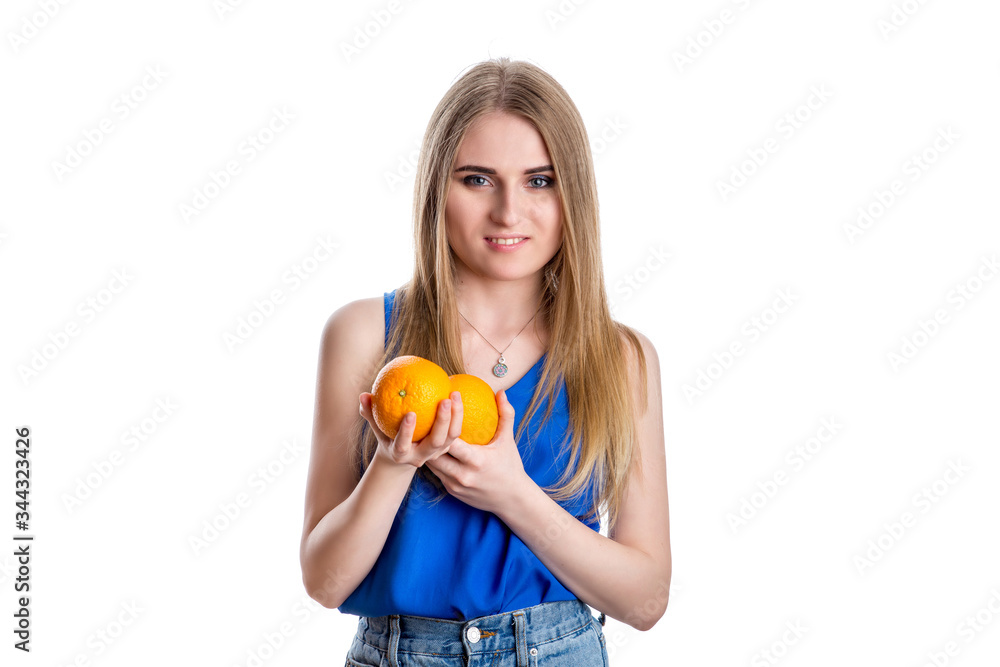 A girl in bright blue jeans and a blouse with a blue cocktail with oranges in her hand A girl in bright blue jeans and a blouse with a blue cocktail with oranges in her hand