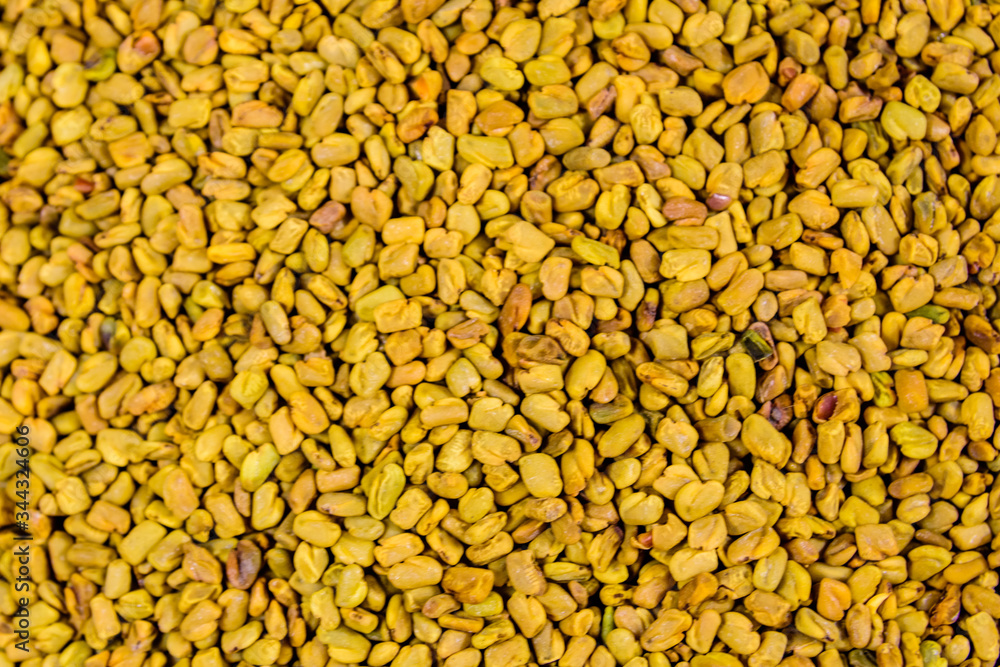 Background of the fenugreek seeds (methi dana, helba or shambala) Background of the fenugreek seeds (methi dana, helba or shambala)