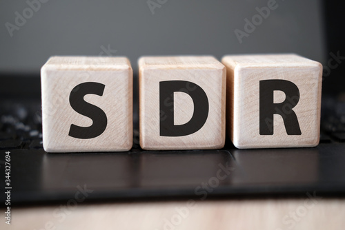 SDR Serpstat Domain Rank - concept on wooden cubes on a black keyboard photo