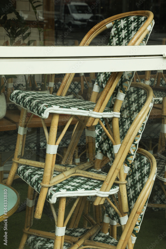 Rattan chairs stacked outside a bistro in paris, France Rattan chairs stacked outside a bistro in paris, France