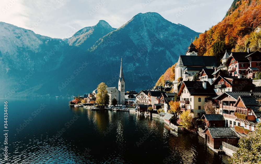 Scenic panoramic view of the famous mountain village in the Austrian Alps. Autumn Landscape. Hallstatt, Austria. Blue lake, sky and mountains. Beautiful and cozy town.Postcard concept.