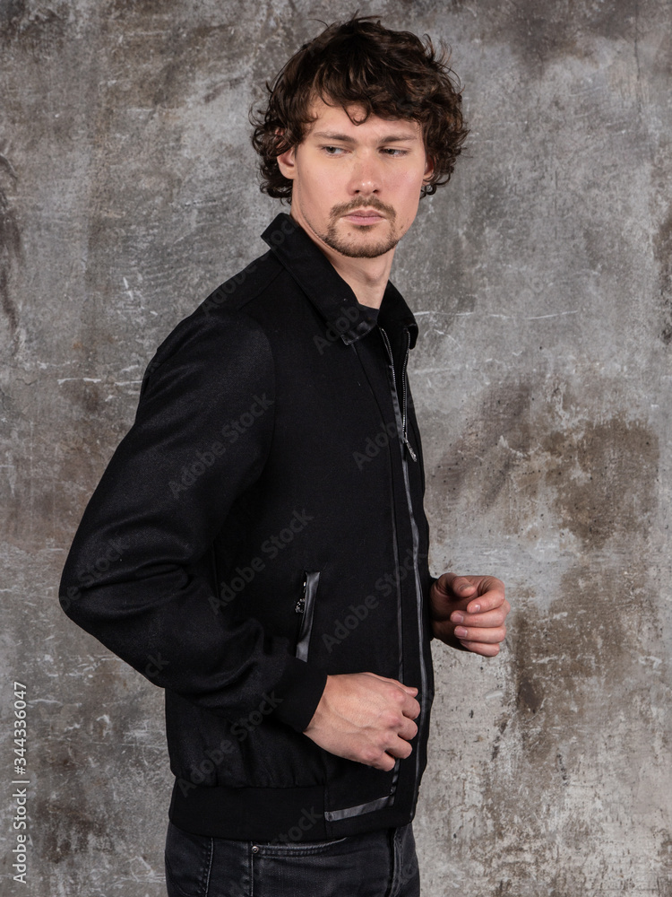 Studio portrait of attractive young man. Young Male Fashion Model Posing In Casual Outfit. 