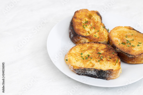 French toast served on the white plate with white background with copy space