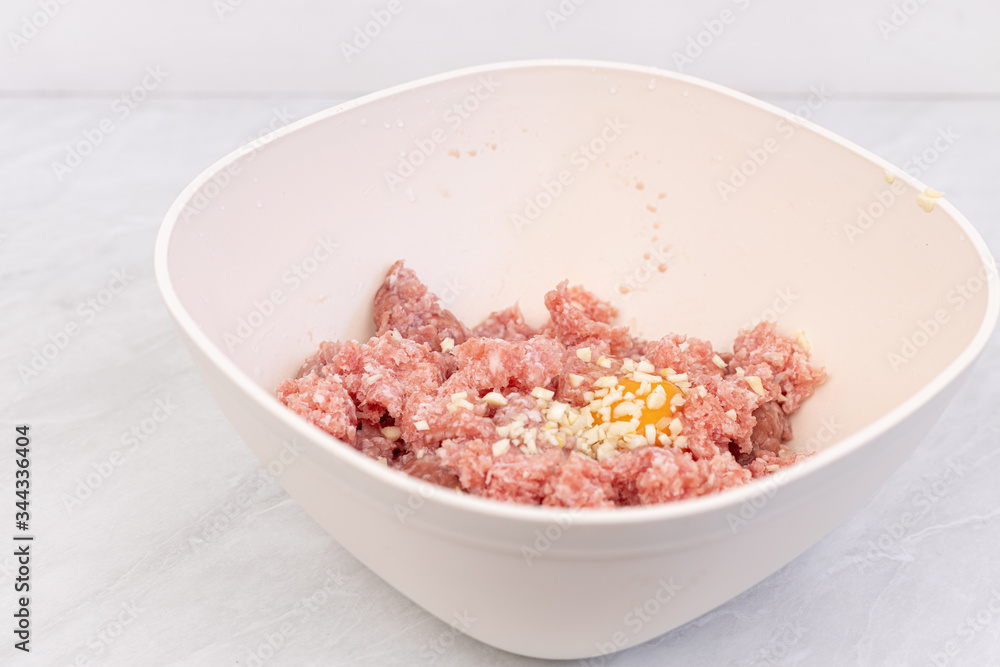 Raw minced meat with smashed eggs and chopped onion mixture for meatballs Raw minced meat with smashed eggs and chopped onion mixture for meatballs