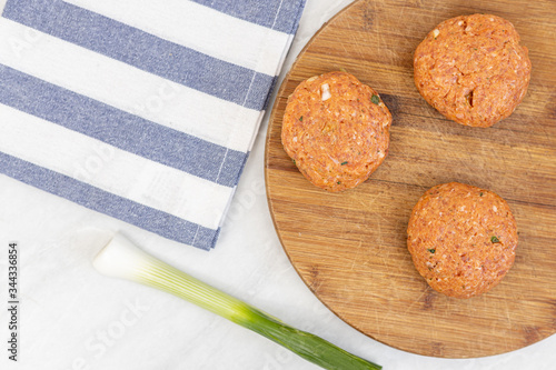 Raw minced meat meatballs on the wooden board ready for frying