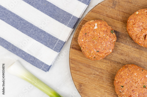 Raw minced meat meatballs on the wooden board ready for frying