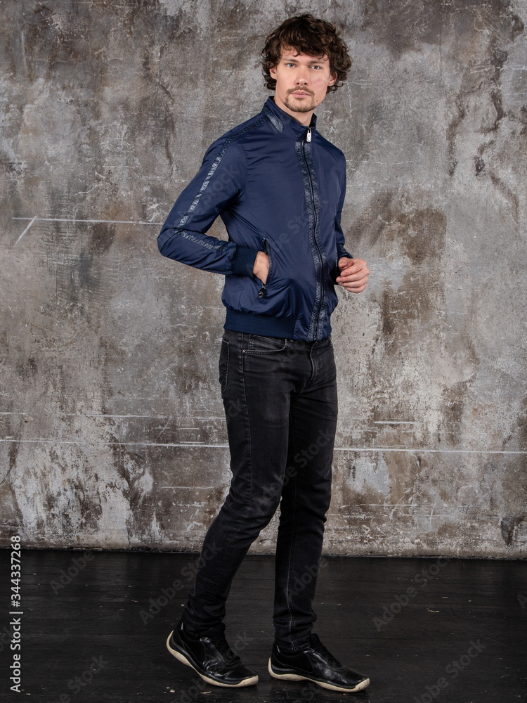 Full length studio portrait of attractive young man. Young Male Fashion Model Posing In Casual Outfit. 