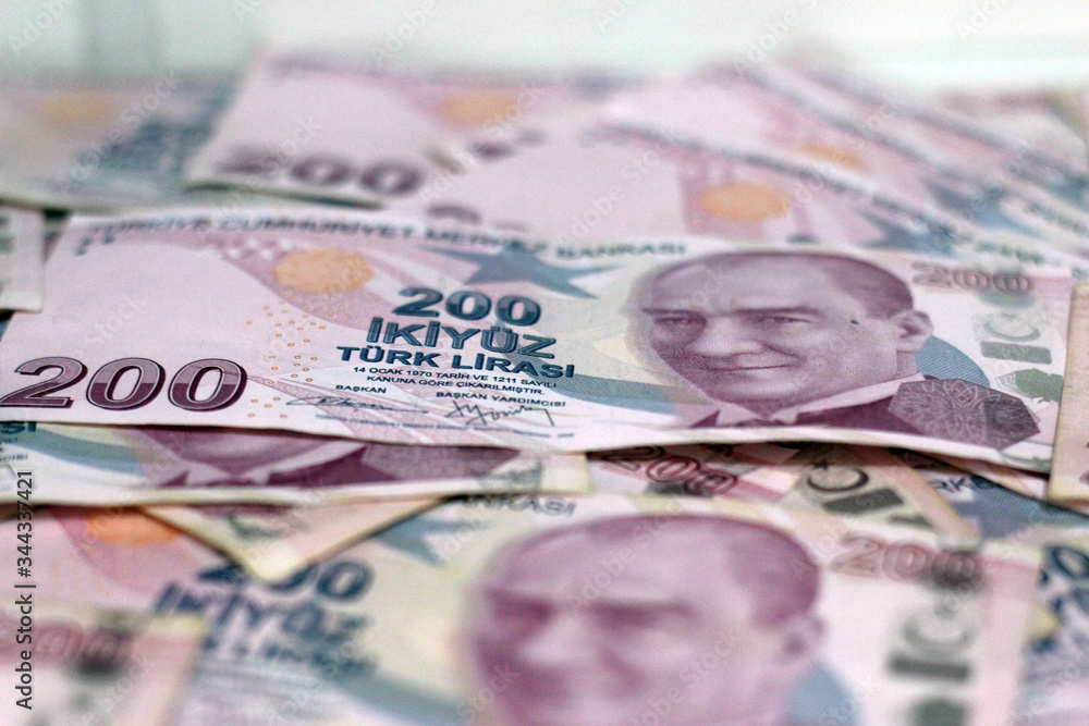 American dollar banknotes and Turksh Lira banknotes side by side on white background. American dollar banknotes and Turksh Lira banknotes side by side on white background.