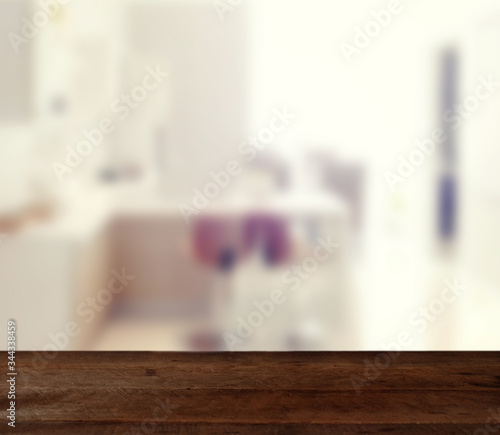 wood table on blur modern living room interior background - can used for display or montage your products