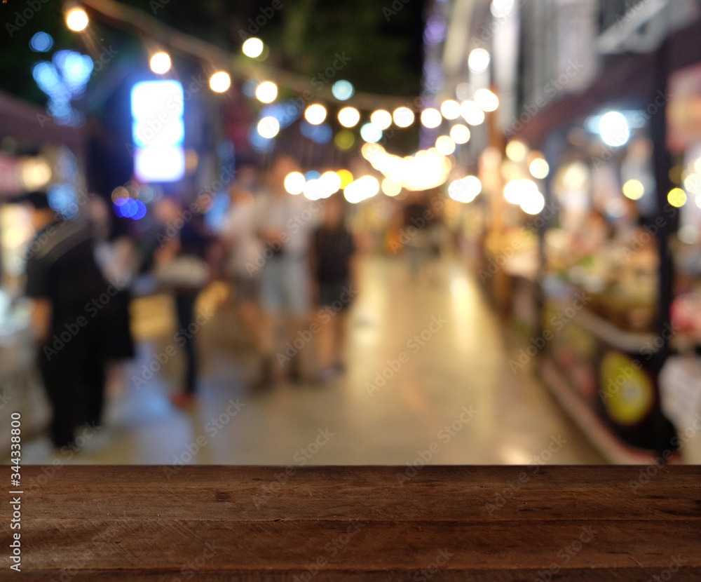 Empty wood table top on blur abstract Night Festival Event Party background. can be used for display or montage your products