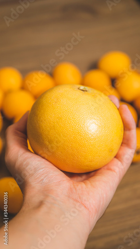 Big grapefruit with medlars at background