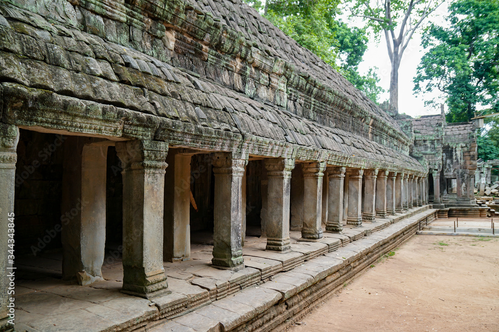 Preah Khan corridor, ancient walls and columns in the temple of the Big Circle of Angkor Wat complex, outside, daytime                       