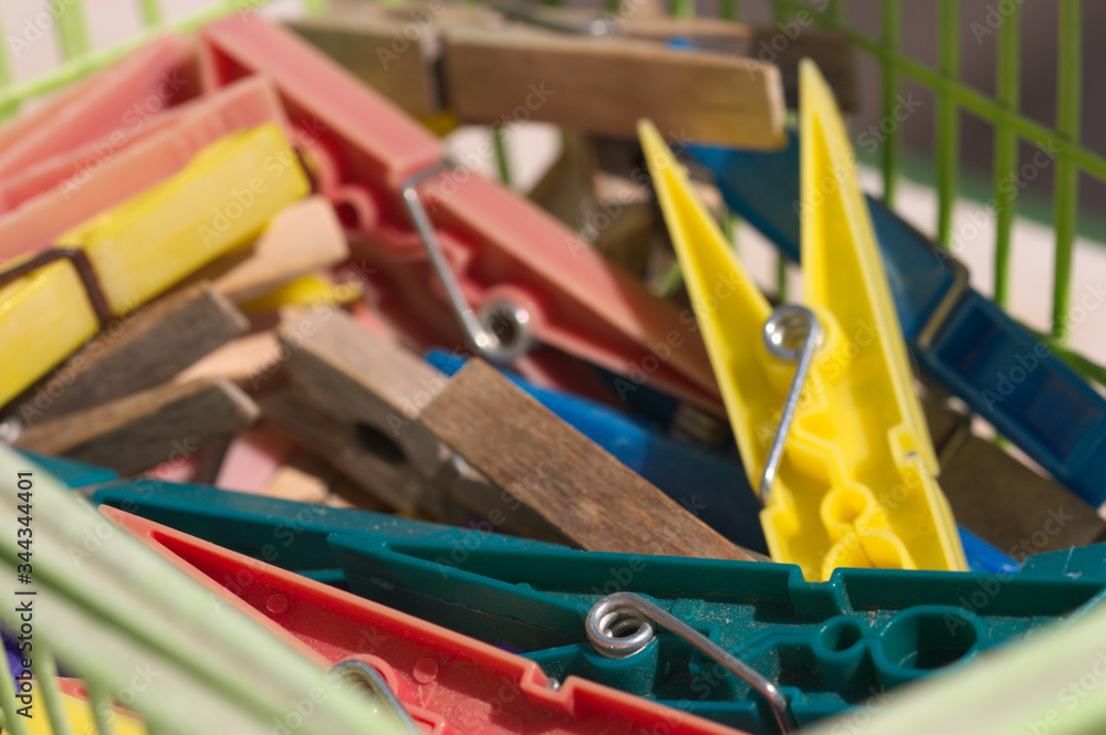 Closeup of a basket full of multicolored clothespins