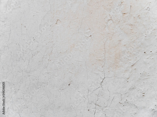 Beige stucco wall crackle surface. Light beige textured background. Grunge texture.