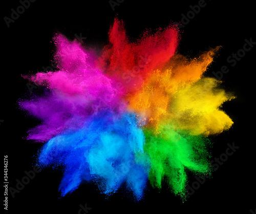 colorful rainbow holi paint color powder explosion isolated on dark black background. peace rgb gaming beautiful party concept photo