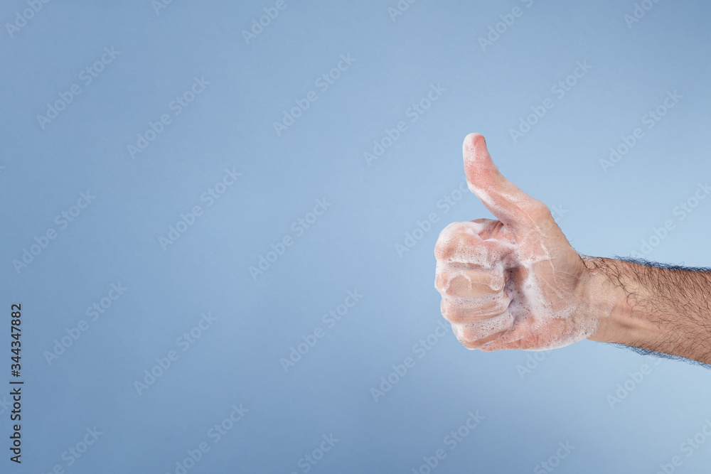 Hand with soap suds making the OK gesture. Hand with soap suds making the OK gesture.