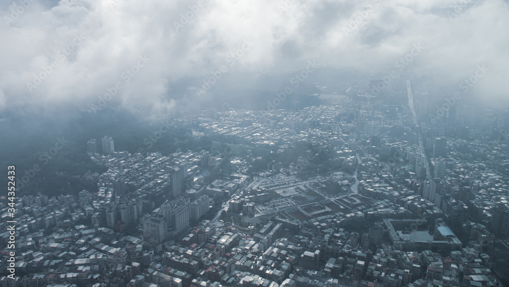 Obraz premium The view across Taipei, captial of Taiwan, from the top of Taipei 101, the second largest building in the world,shoot after raining with fog.