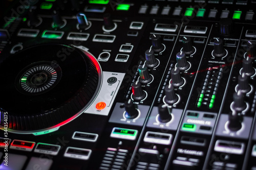Fancy Big DJ Controller with knobs and buttons for live party performance or in music recording studio