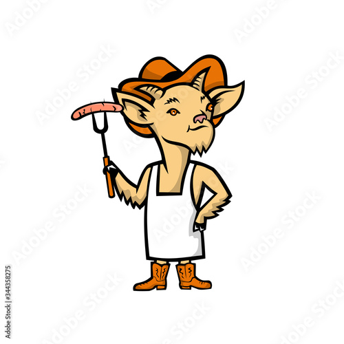 Mascot icon illustration of a Billy goat who is a barbecue or bbq chef holding a sausage and wearing cowboy hat, boots and apron standing viewed from front on isolated background in retro style.