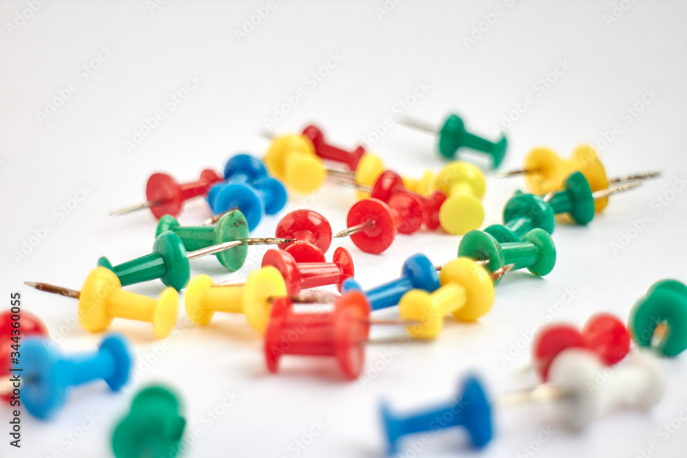 thumbtacks scattered on white background thumbtacks scattered on white background
