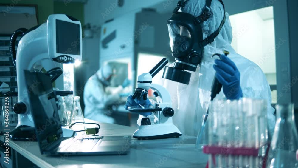 Medical research of antibodies to COVID-19. Laboratory researcher is working with a microscope Medical research of antibodies to COVID-19. Laboratory researcher is working with a microscope