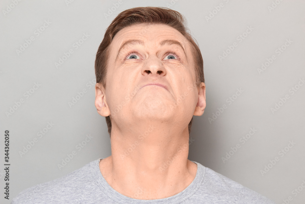 Portrait of blond mature man with angry annoyed expression Portrait of blond mature man with angry annoyed expression