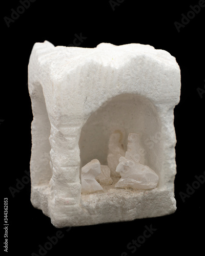 handcrafted Christmas decoration caved salt block with a nativity scene on black background