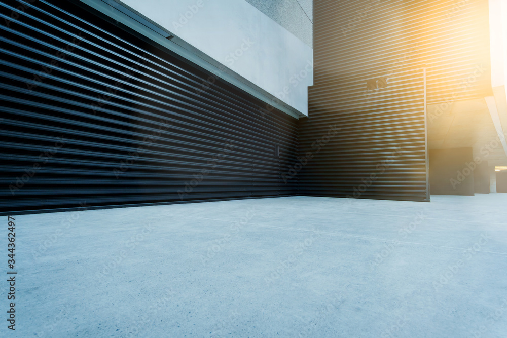 Obraz premium Empty concrete street with urban black steel industrial door, abstract architecture with corridor