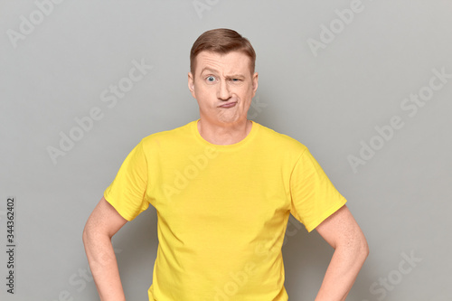 Portrait of funny blond mature man with goofy perplexed expression © Andrei Korzhyts