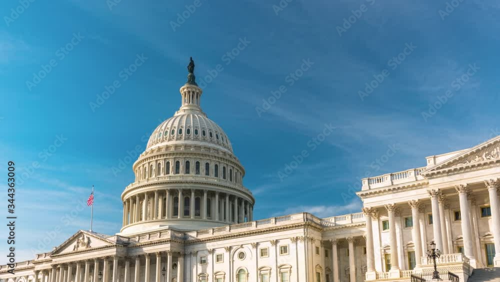 Moving timelapse US Capitol in Washington DC over blue sky Moving timelapse US Capitol in Washington DC over blue sky