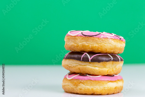 Colorful donuts stacked isolated on white