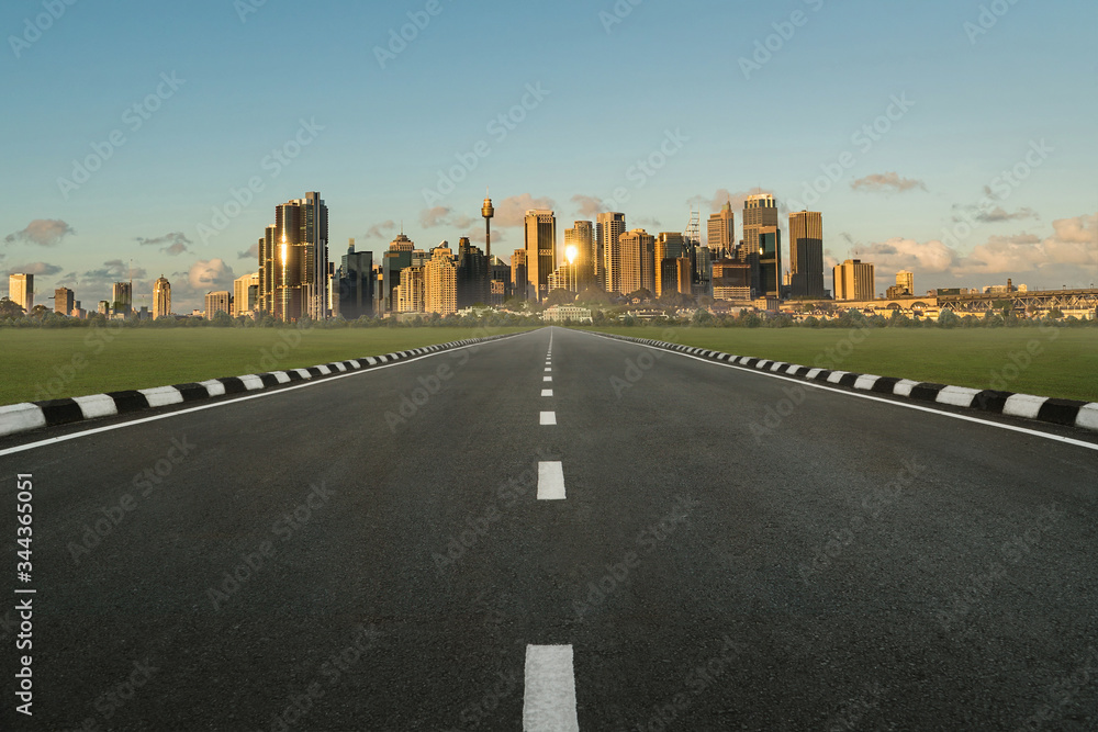 asphalt road in perspective view with urban cityscape in sunset, empty highway with skyline city skyscraper in Sydney