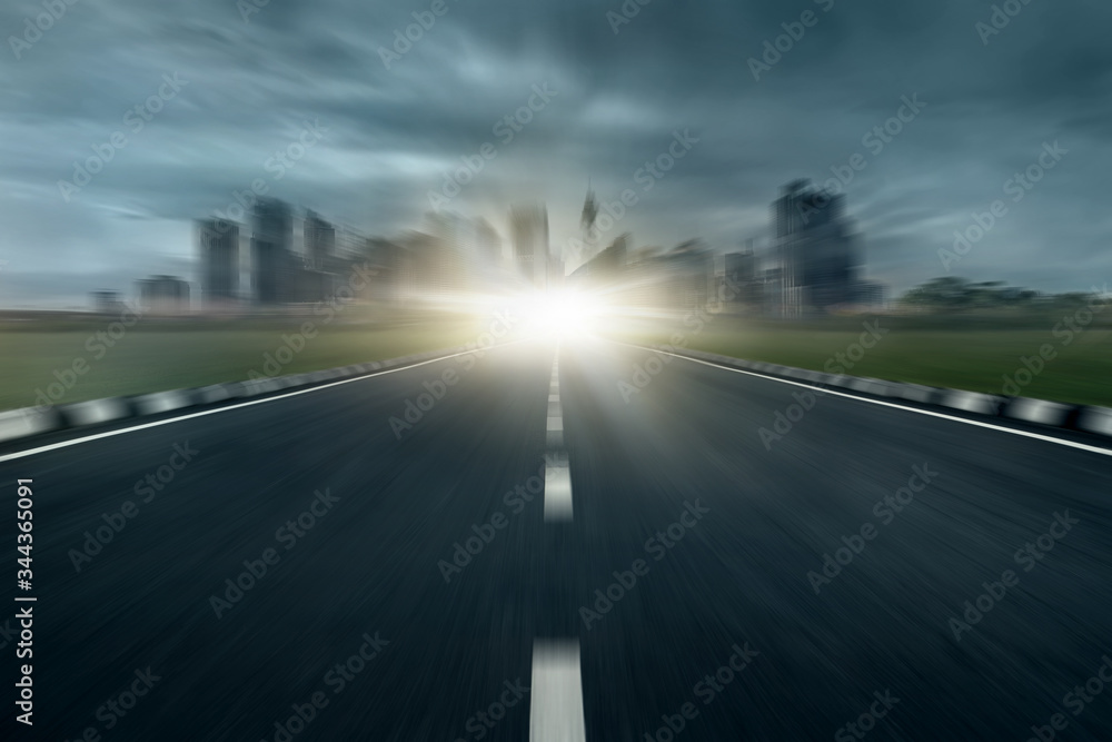 dramatic zooming asphalt road with modern cityscape skyline, motion blur highway roadside with urban city skyscraper stormy day