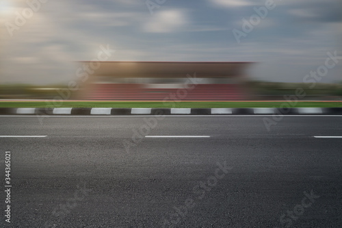 empty asphalt road with speedy f1 background, speeding highway roadside stadium building 