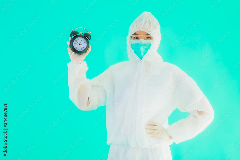 Portrait beautiful young asian doctor woman wear ppe suite and mask show clock Portrait beautiful young asian doctor woman wear ppe suite and mask show clock