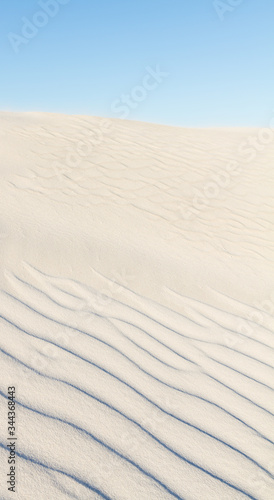 Portrait of white sand dunes in Western Australia with blue sky