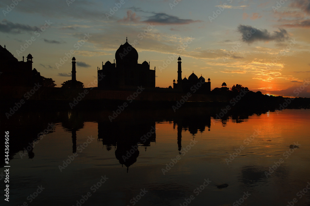 reflection of the Taj mahal mausoleum on the yamuna river,in the city of agra in the uttar pradesh province in India