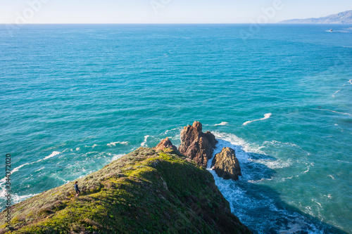 A Girl Hiking and Exploring Coastal Cliffs and Waves in Big Sur, California