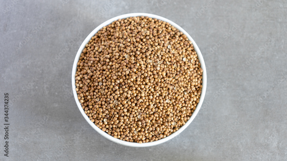 Coriander Seeds Bowl Top View Neutral background with negative space to add captions Coriander Seeds Bowl Top View Neutral background with negative space to add captions