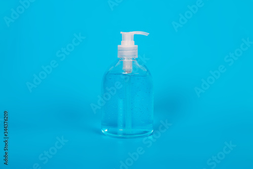 Alcohol gel Sanitizer hand gel cleaners for anti Bacteria and virus on Blue Background, People using alcohol gel to wash hands to prevent Coronavirus (COVID-19)