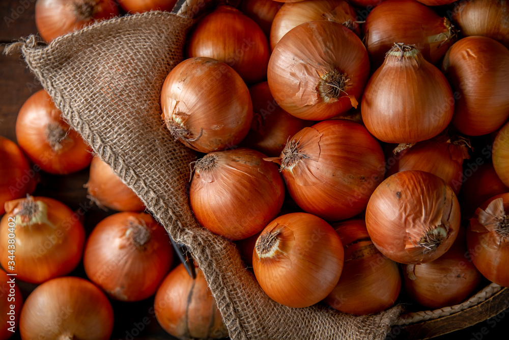 Fresh ripe onions in wooden bucket. Fresh ripe onions in wooden bucket.