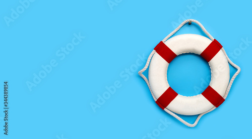 Lifebuoy on blue background. Copy space photo
