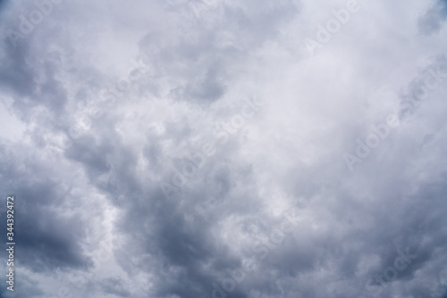 Cloudy Sky Background with thick layers of grey clouds 